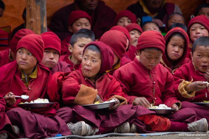 Lho children monk eating Manaslu circuit 